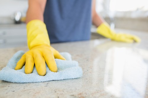 Professional carpet cleaning technician working carefully around furniture